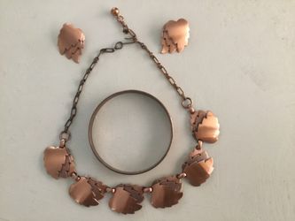 Vintage mid-century modern copper leaf jewelry set features layered, textured leaf motifs across a matching necklace, earrings, and bangle bracel