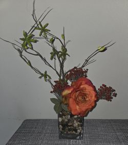 Vase With Stones And Orange Rose