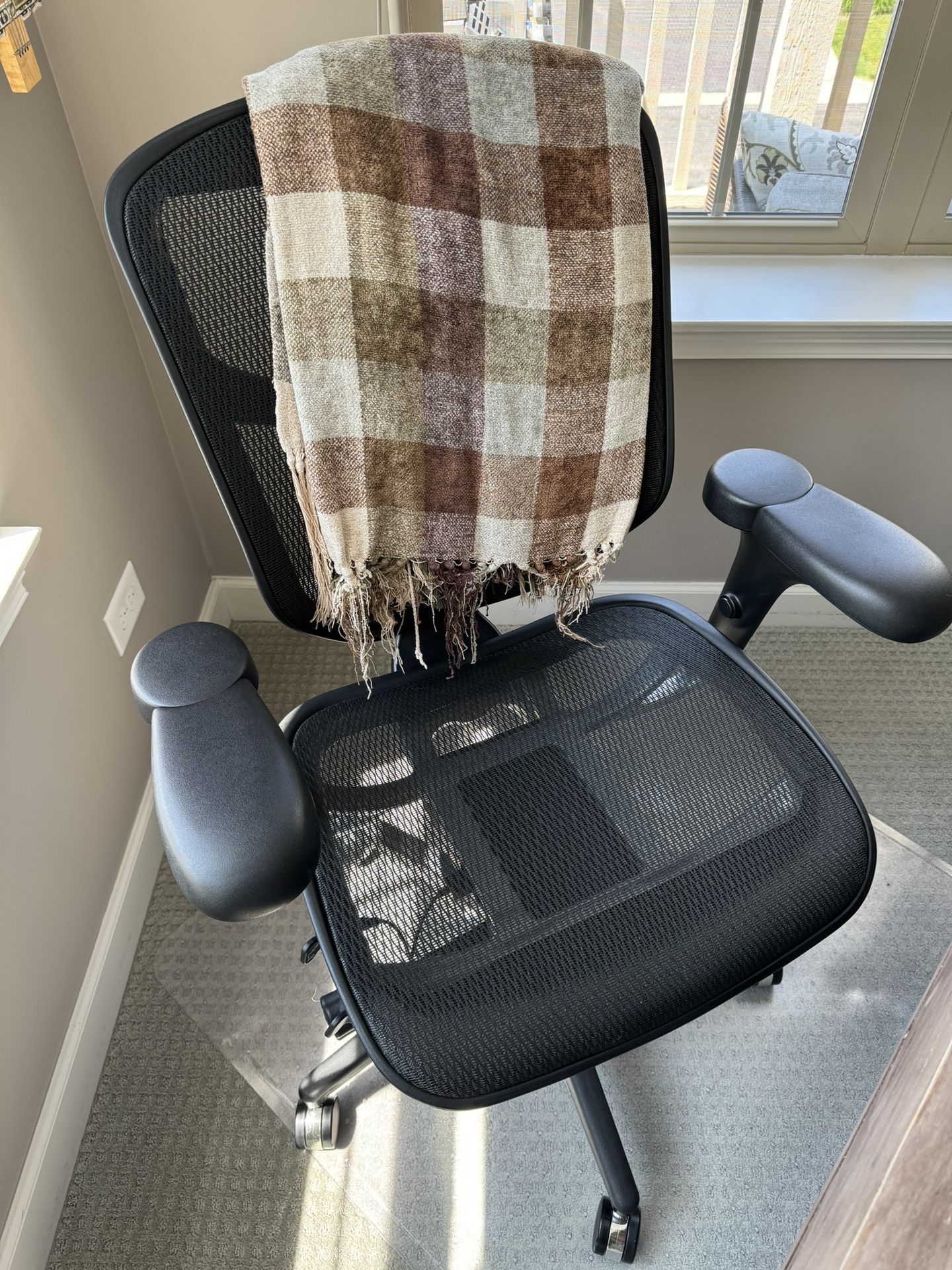 Black office chair + plastic rolling mat