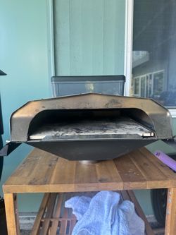 Traeger pizza oven, used twice, and small bin of pellets