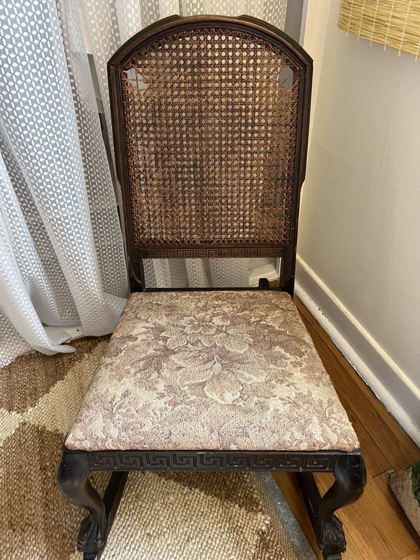 Antique Rocking Chair with Cane Back and Floral Upholstery