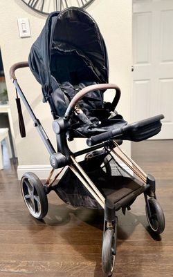 Premium black Cybex Priam stroller system with a rose gold frame