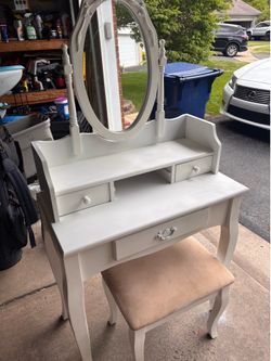 White vanity with mirror and chair