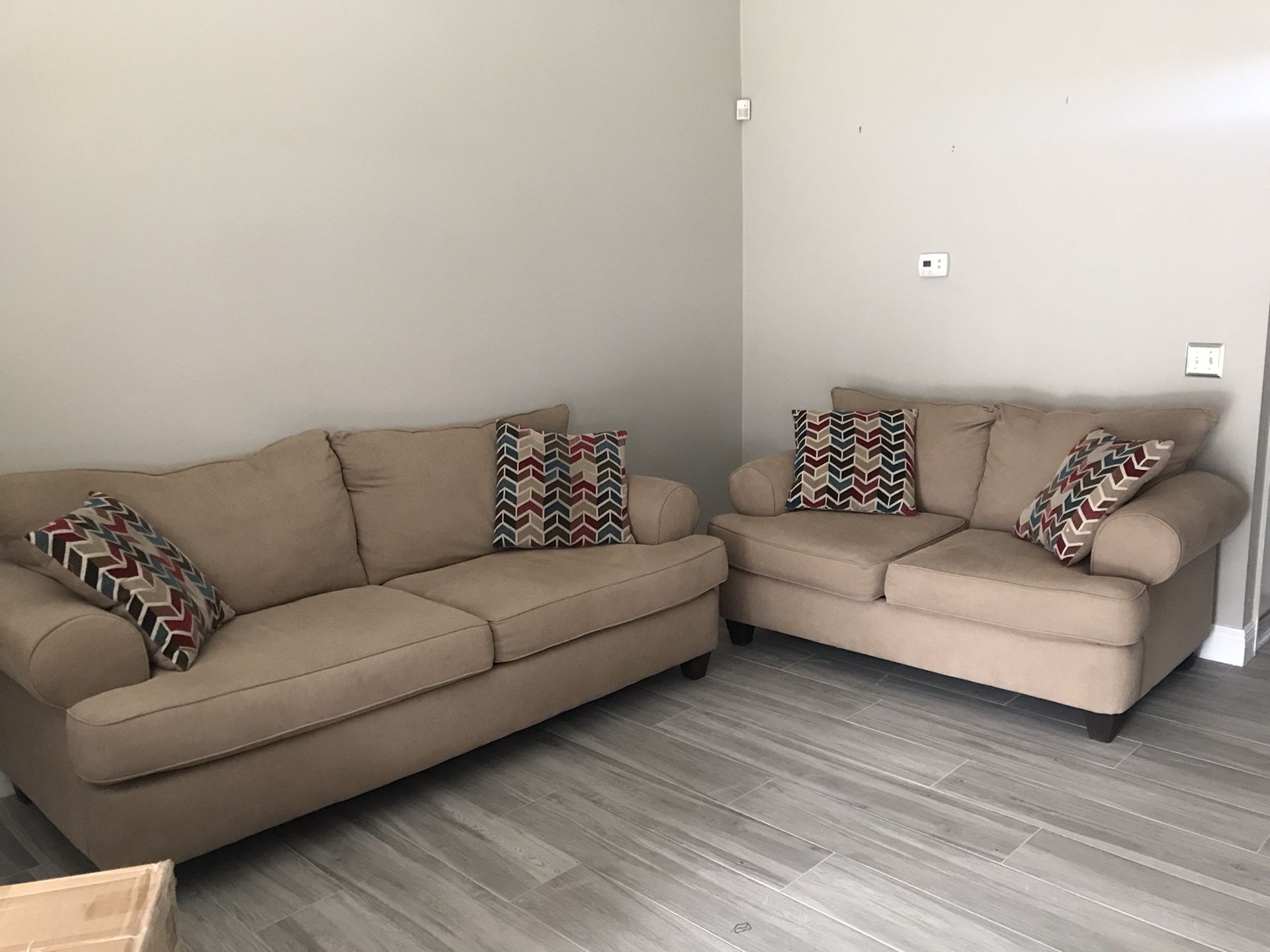 Beige couch and loveseat