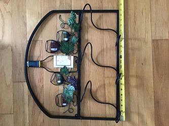 Wall iron wine rack sorry pic isn’t right sided to view holds 3 bottles never used like new