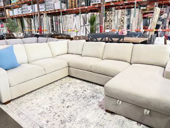 White fabric sectional with storage chaise