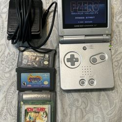Nintendo Gameboy Advance SP Silver with charger, and 4 games