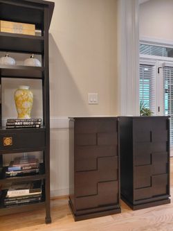 Wood dark brown accent cabinets on a swivel base.