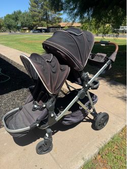 Mocking bird double stroller with ride along stand.