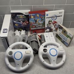 NINTENDO WII with WII SPORTS , MARIO KART , MARIO GALEXY , SUPER MARIO BROTHERS + 2 WHEELS and 2 RETROMES