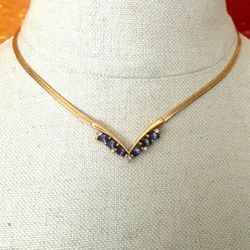 Gold tone Avon vintage Herringbone Necklace with purple Stones