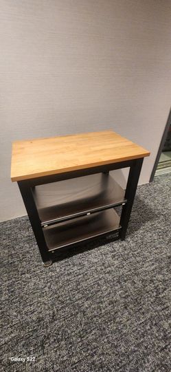 black IKEA Stenstorp kitchen cart with a butcher block top.