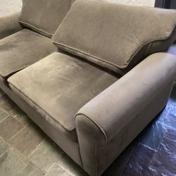 Gray plush loveseat with sleeper excellent condition
