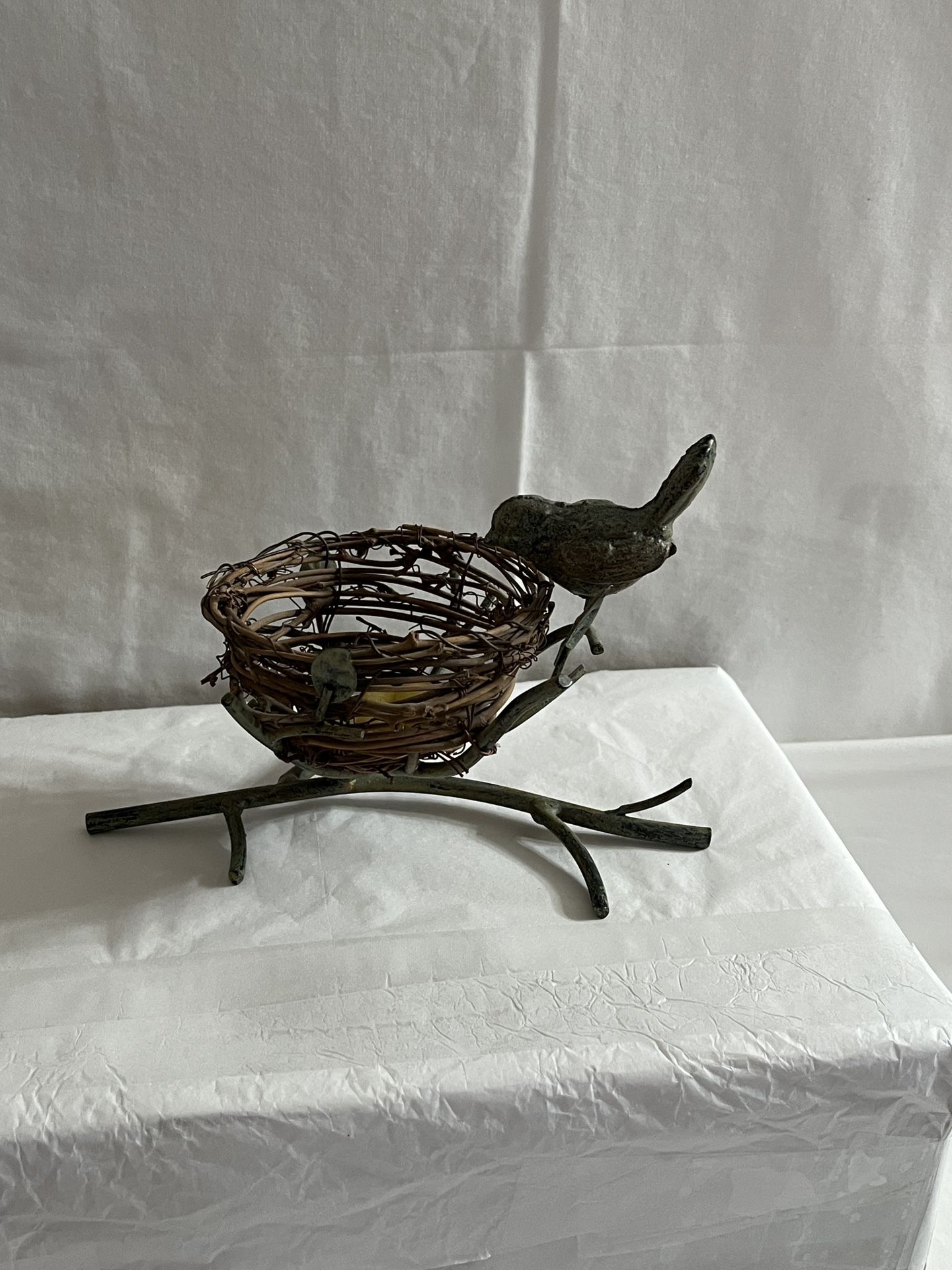 Metal bird with nest