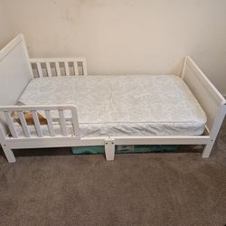 White toddler bed with mattress