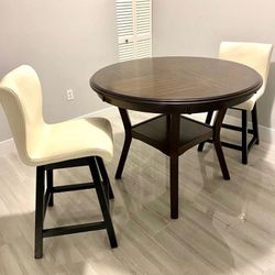 Wooden round table with two swivel chairs