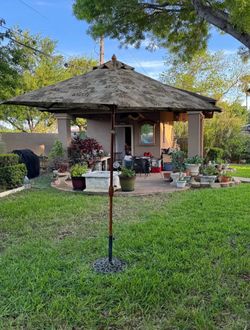 Outdoor Wood umbrella with cast iron stand.