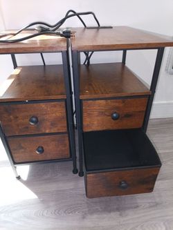 Two faux wood nightstands with charging ports