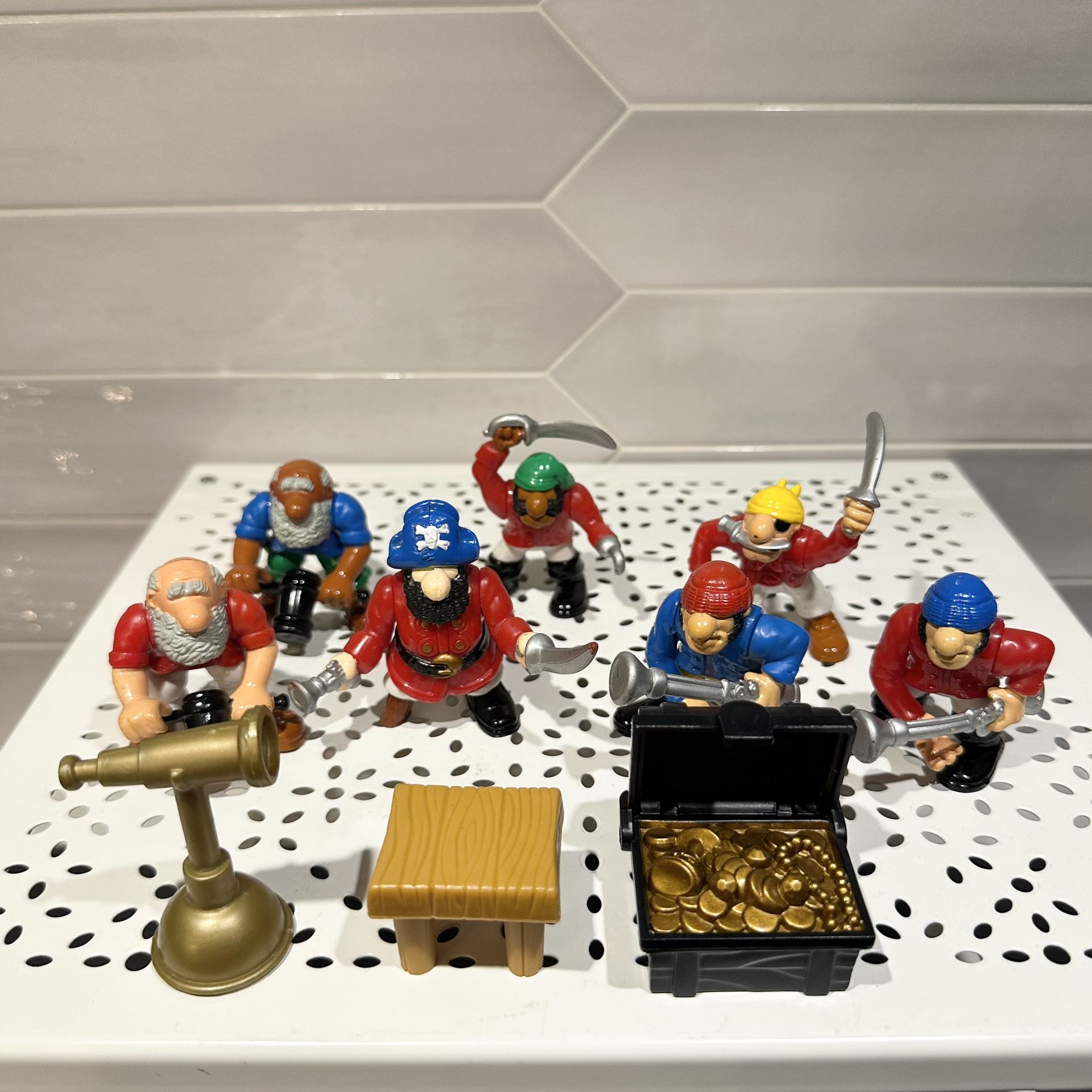 Vintage 1994 Fisher-Price great adventures figures set 10 pieces. 6 pirates, one pirate captain, one treasure chest, one table and one telescope.