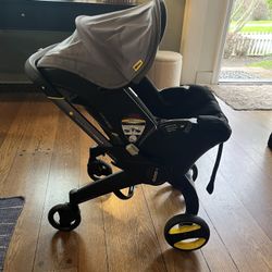 Doona+ Car Seat & Stroller w/ Latch Base & Padded Travel Bag