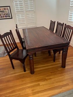 Six-chair Spanish/Mexican-style wood table.