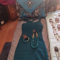 Turquoise Dress Necklace Bracelet And A Bag With Wheels