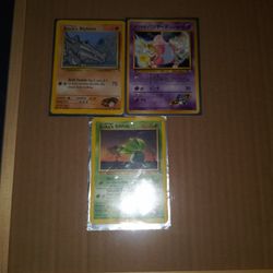 3 Pokemon Cards With Face On Bottom