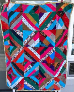 Lots of different shapes and patterns in great retro colors. Mostly vintage corduroy with some velvet pieces. It’s a nice heavier weighted quilt .