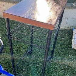 John Boos Metropolitan wire cart with a butcher block top and black shelves