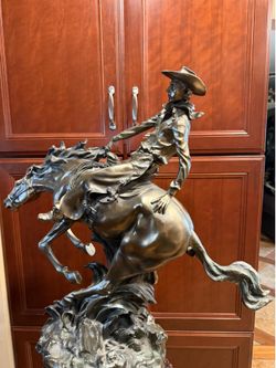 STATUES OF COWBOY ON HORSE