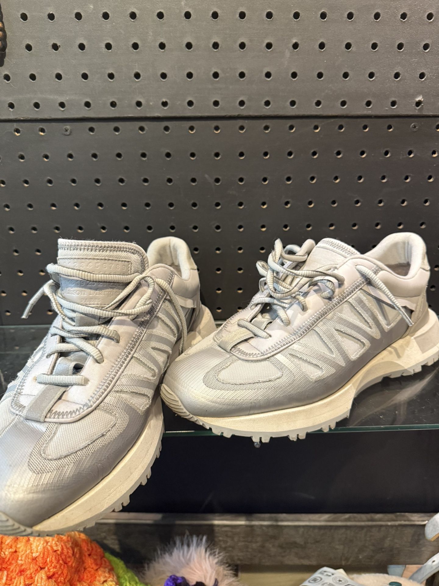 The Maison Margiela Nylon Printed Athletic Sneakers in size 44 (U.S. size 11) are a rare and stylish addition to any man's shoe collection. Featuring