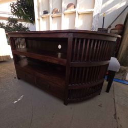 Solid Wood Curved-Edge Entertainment Center With Shelves And Drawers.