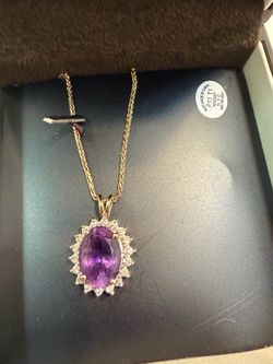 Purple charm with diamonds surrounding