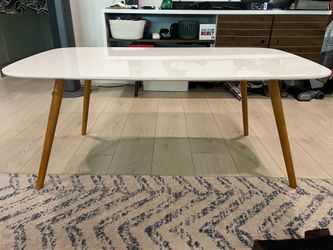 Modern white coffee table with wood legs