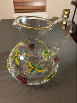 Glass pitcher with floral design.