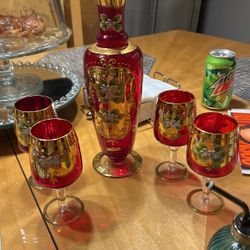 Vintage red glass decanter with four glasses