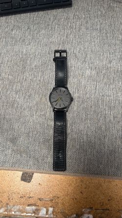 Nixon Sentry Leather wristwatch in gunmetal with a black leather strap.