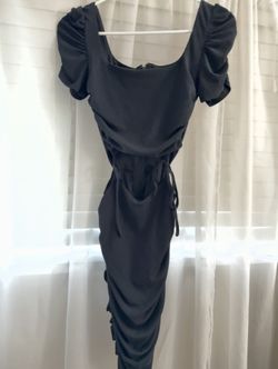 Black mini dress with ruched detail and open stomach