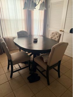 Brown dining room table with chairs