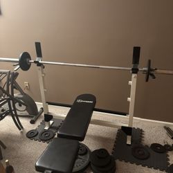 bench press with a bunch of weights and other workout equipment throw me an offer 