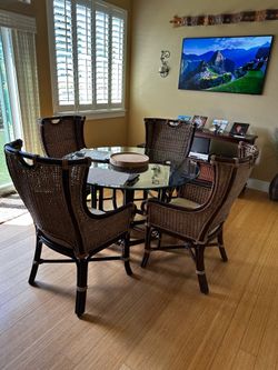 Rattan 47” round glass top  dining table and 4 chairs.
