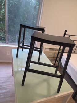 2 black wood barstools