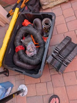 Dump hoses with ladder rack and tote box.