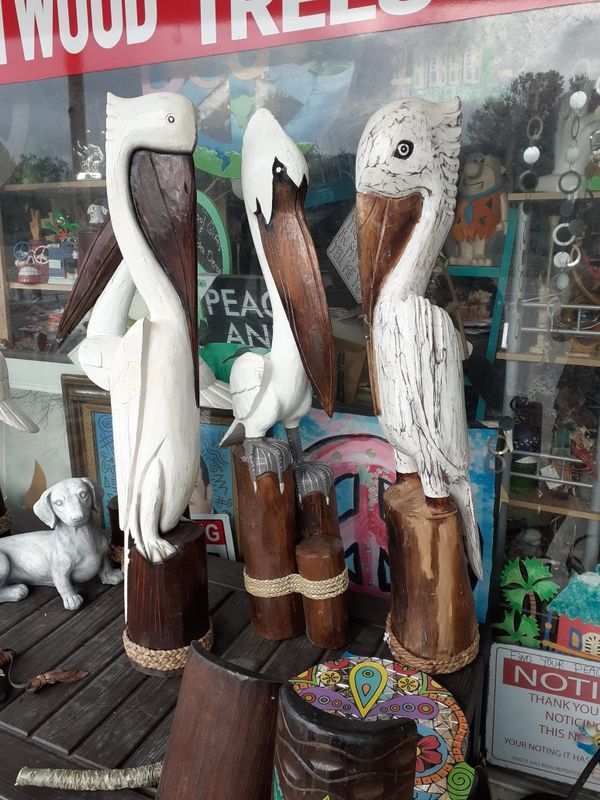 Cool really large carved wooden Pelican statues on post
