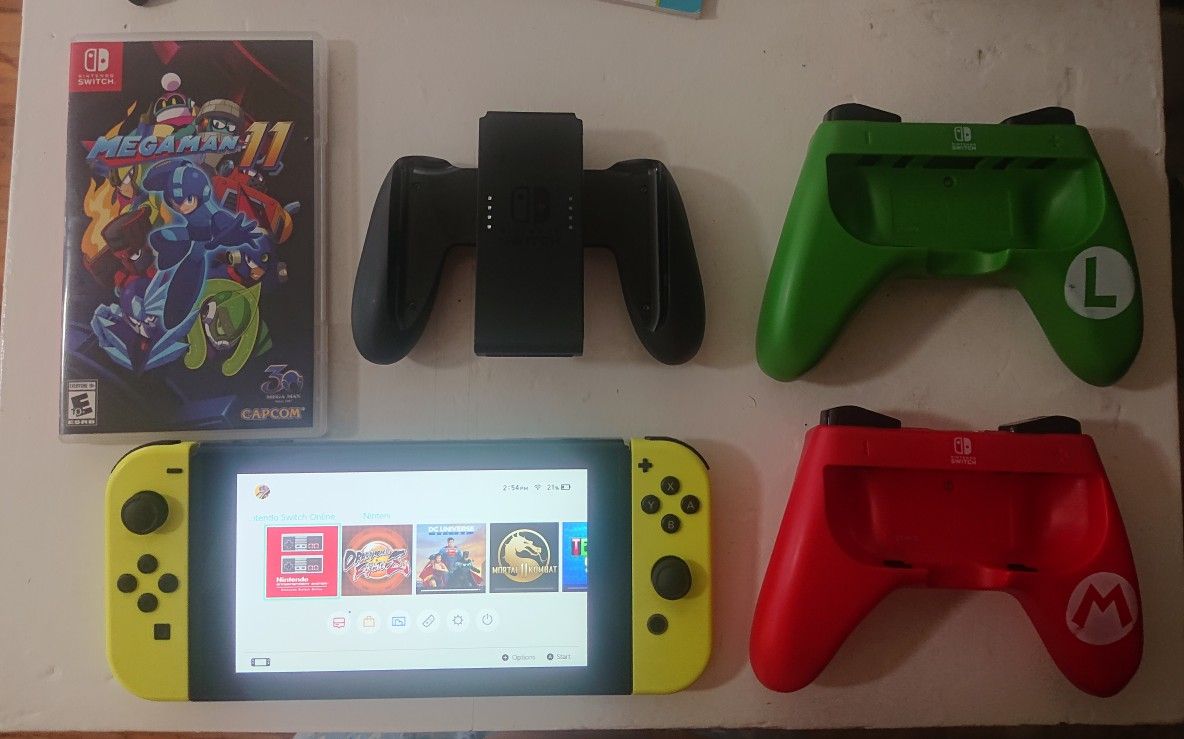 Nintendo switch with 15 games, two joysticks, joy cons pad and 128gb SD card for sale