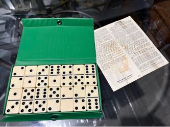 This item is a vintage dominoes set housed in a green vinyl case by Milton Bradley   VINTAGE DOMINO’S IN CASE