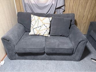 Gray sofa and love seat with throw pillows
