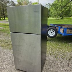 Aman at a stainless steel refrigerator