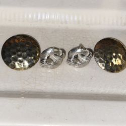 Two vintage pair of earrings one pair is a size of a half dollar go tone. The other is clip on silver with the makers’s name stamped on it.