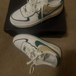 Nike Air Force 1 sneakers in white with green and beige accents #airforce1 #basketball